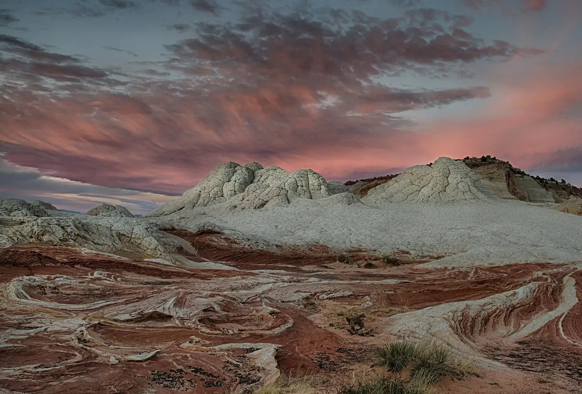 Red and white sandstone at White Pocket under a pink sky